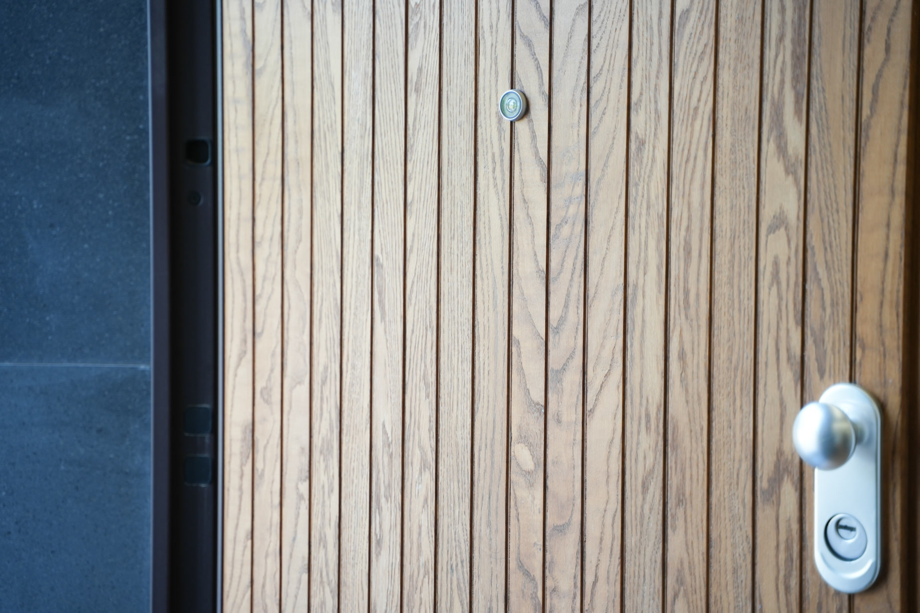 La porta a doghe di legno con maniglia in acciaio
